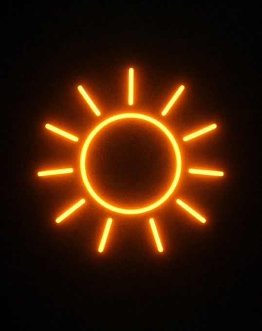 Sonne Eine abstrakte Sonne als Neonbild auf Backsteinwand